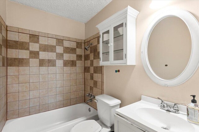 1307 Meadgreen Dr, Austin, TX 78758 - full bathroom featuring a textured ceiling, vanity, toilet, and  shower combination