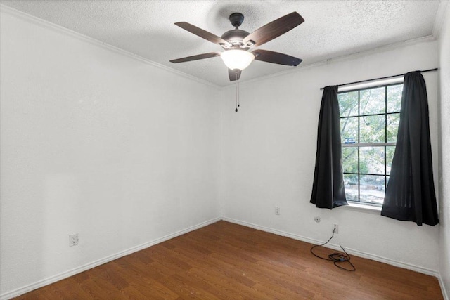 1307 Meadgreen Dr, Austin, TX 78758 - spare room with wood finished floors, a textured ceiling, ornamental molding, ceiling fan, and baseboards