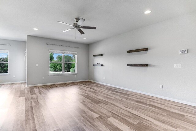 4333 Buffalo Ford Rd, Georgetown, TX 78628 - unfurnished living room with plenty of natural light, a ceiling fan, light wood finished floors, and recessed lighting