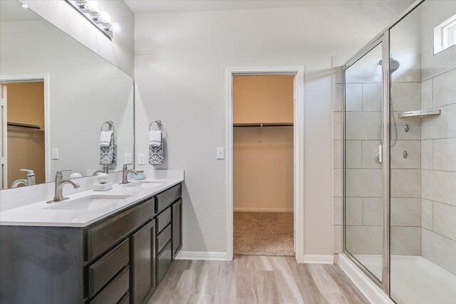 4333 Buffalo Ford Rd, Georgetown, TX 78628 - full bath with a walk in closet, wood finished floors, double vanity, and a shower stall