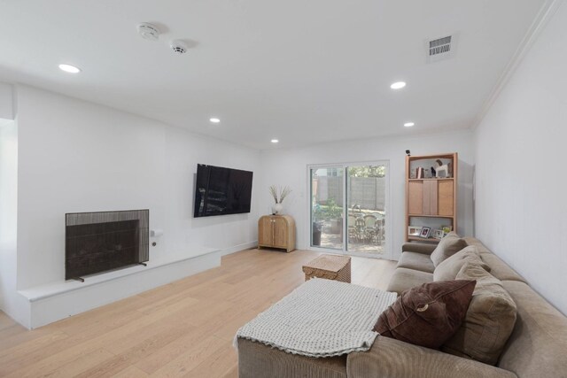 7905 Havenwood Dr, Austin, TX 78759 - living room featuring light wood-type flooring, recessed lighting, ornamental molding, and heating unit