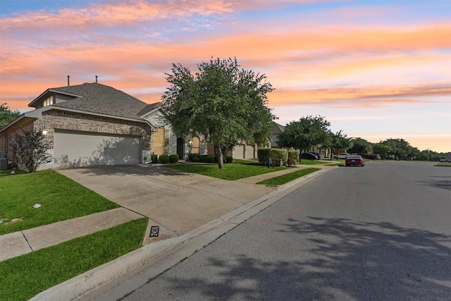 2415 Berkshire Way, Cedar Park, TX 78613 - view of front of home with stone siding, a garage, driveway, and a front yard