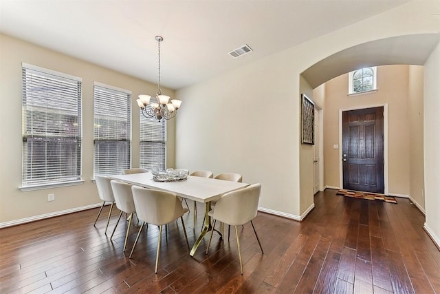 2415 Berkshire Way, Cedar Park, TX 78613 - dining space featuring arched walkways, a chandelier, and dark wood finished floors