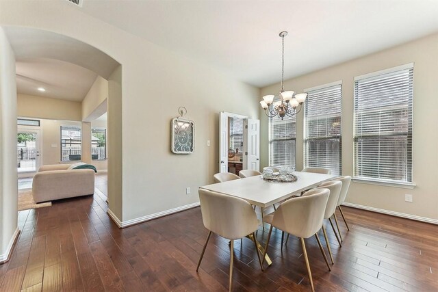 2415 Berkshire Way, Cedar Park, TX 78613 - dining area with arched walkways, a chandelier, dark wood finished floors, and recessed lighting