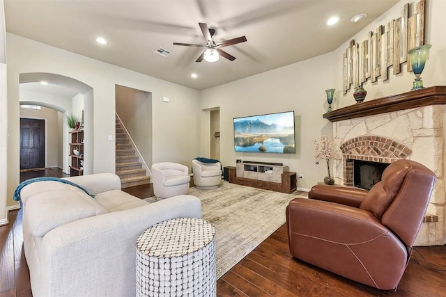 2415 Berkshire Way, Cedar Park, TX 78613 - living area featuring a stone fireplace, a ceiling fan, dark wood finished floors, recessed lighting, and arched walkways