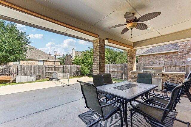 2415 Berkshire Way, Cedar Park, TX 78613 - fenced backyard featuring exterior kitchen, outdoor dining space, a patio, and a ceiling fan