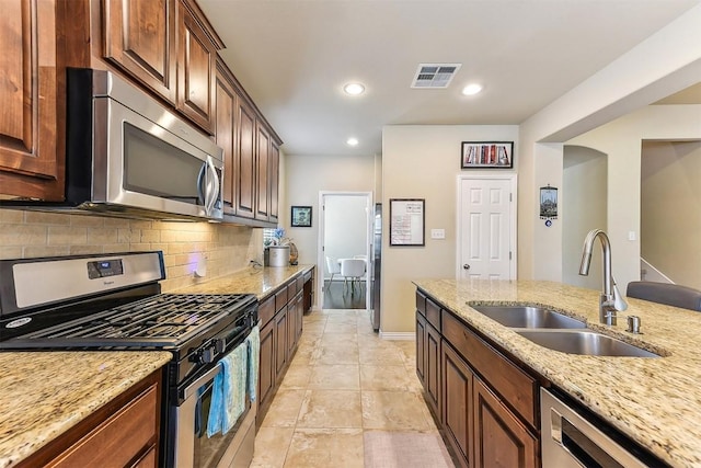 2415 Berkshire Way, Cedar Park, TX 78613 - kitchen featuring appliances with stainless steel finishes, backsplash, light stone countertops, and recessed lighting