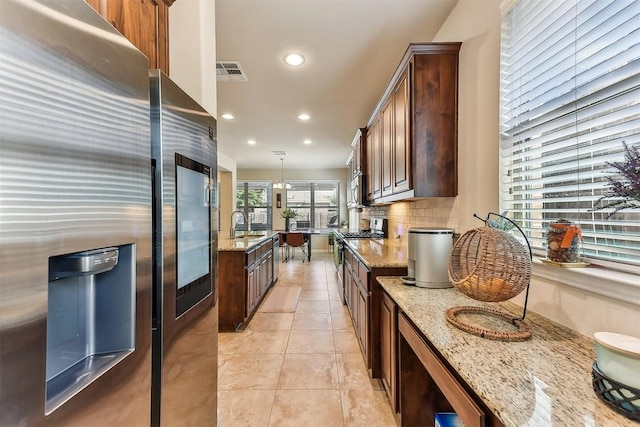 2415 Berkshire Way, Cedar Park, TX 78613 - kitchen featuring stainless steel appliances, recessed lighting, light stone counters, tasteful backsplash, and light tile patterned floors