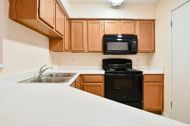 2450 Wickersham Ln Unit 718, Austin, TX 78741 - kitchen featuring black appliances, a sink, and light countertops