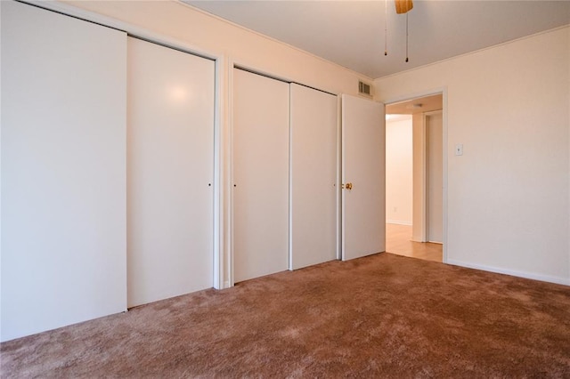 2450 Wickersham Ln Unit 718, Austin, TX 78741 - unfurnished bedroom featuring carpet flooring, multiple closets, and ceiling fan
