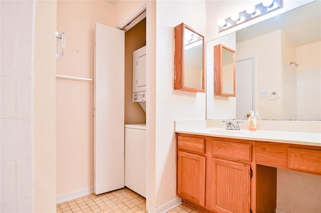 2450 Wickersham Ln Unit 718, Austin, TX 78741 - full bathroom featuring stacked washer / drying machine, vanity, and baseboards