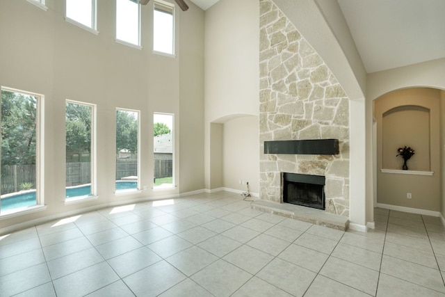 2937 Castellan Ln, Round Rock, TX 78665 - unfurnished living room with a high ceiling, a fireplace, and tile patterned flooring