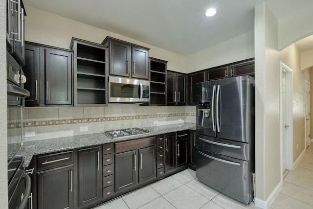 2937 Castellan Ln, Round Rock, TX 78665 - kitchen with appliances with stainless steel finishes, open shelves, light tile patterned floors, and light stone counters