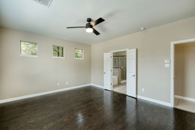 2937 Castellan Ln, Round Rock, TX 78665 - unfurnished bedroom featuring wood finished floors, multiple windows, ensuite bathroom, and ceiling fan