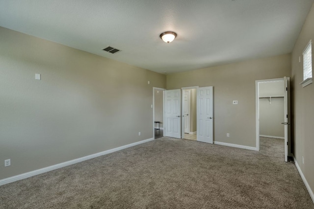 2937 Castellan Ln, Round Rock, TX 78665 - unfurnished bedroom featuring a walk in closet, carpet flooring, and a closet