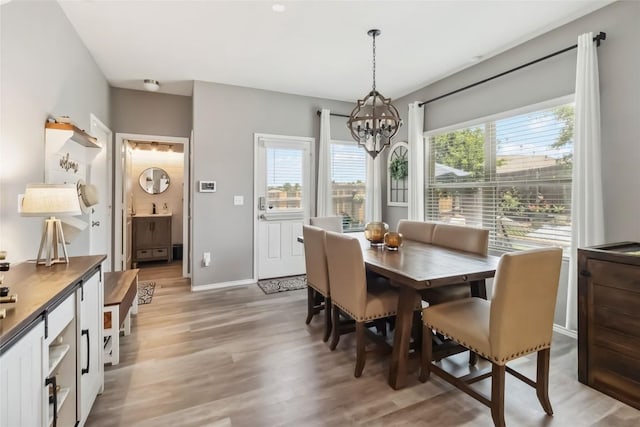 10901 Rome Ave, Austin, TX 78747 - dining room featuring a chandelier and light wood-style flooring
