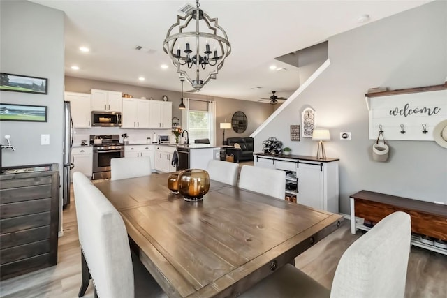 10901 Rome Ave, Austin, TX 78747 - dining room featuring a chandelier, a ceiling fan, light wood finished floors, and recessed lighting