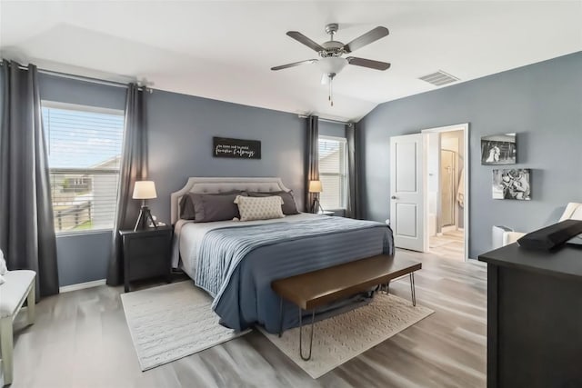 10901 Rome Ave, Austin, TX 78747 - bedroom featuring wood finished floors, lofted ceiling, ensuite bath, and a ceiling fan
