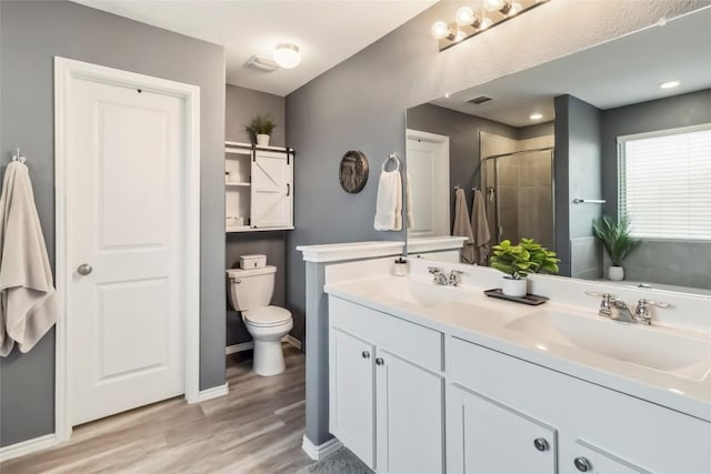 10901 Rome Ave, Austin, TX 78747 - bathroom with a stall shower, wood finished floors, and double vanity