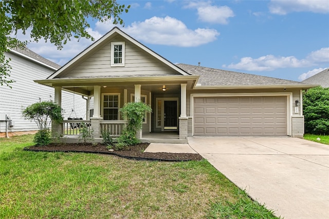 168 Hickory Ln, Georgetown, TX 78633 - view of front of home with an attached garage, a porch, concrete driveway, and a front yard