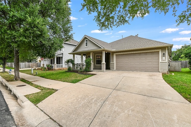 168 Hickory Ln, Georgetown, TX 78633 - view of front of property with a garage, a porch, driveway, and roof with shingles