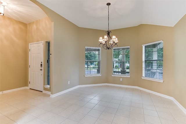 168 Hickory Ln, Georgetown, TX 78633 - empty room with arched walkways, a chandelier, light tile patterned floors, lofted ceiling, and baseboards