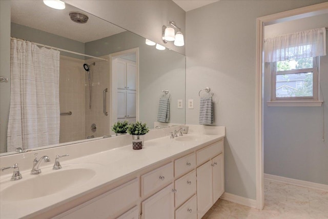 7925 Wheel Rim Cir, Austin, TX 78749 - bathroom featuring a shower with curtain, double vanity, and baseboards