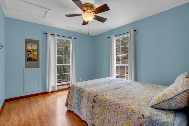 1514 Sunset Cliff Rd, Burnet, TX 78611 - bedroom with wood finished floors, multiple windows, baseboards, and ceiling fan