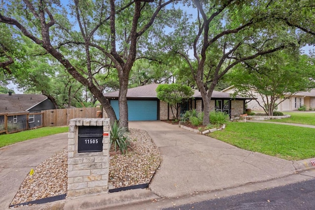 11505 Circle Bend Dr, Austin, TX 78758 - view of front of house with driveway, brick siding, and an attached garage