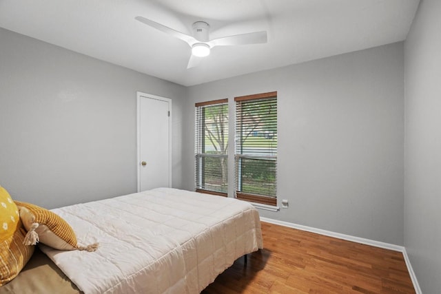 11505 Circle Bend Dr, Austin, TX 78758 - bedroom with baseboards, wood finished floors, and ceiling fan