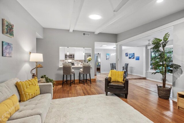 11505 Circle Bend Dr, Austin, TX 78758 - living area with beam ceiling, light wood finished floors, baseboards, and recessed lighting
