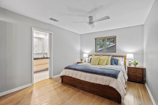11505 Circle Bend Dr, Austin, TX 78758 - bedroom featuring light wood finished floors, baseboards, ensuite bathroom, and ceiling fan