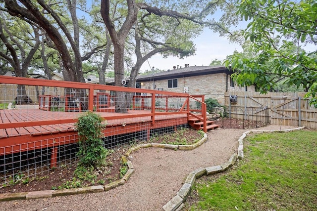 11505 Circle Bend Dr, Austin, TX 78758 - back of property with a fenced backyard, a deck, and stone siding