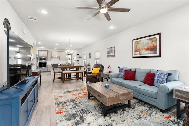 129 Lacey Oak Loop, San Marcos, TX 78666 - living room featuring a ceiling fan, light wood-style floors, recessed lighting, and a chandelier