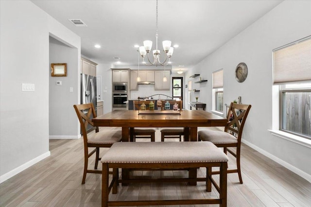 129 Lacey Oak Loop, San Marcos, TX 78666 - dining space featuring light wood-style floors, a chandelier, baseboards, and recessed lighting