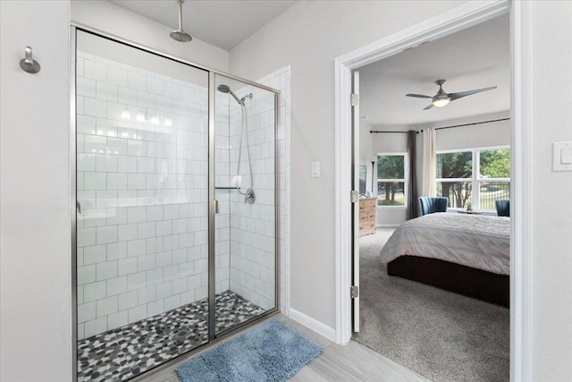 129 Lacey Oak Loop, San Marcos, TX 78666 - full bath featuring connected bathroom, a stall shower, ceiling fan, and baseboards
