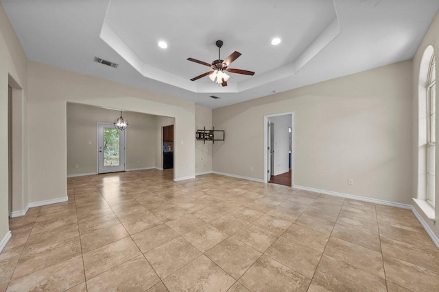 136 W Maple Dr, Granite Shoals, TX 78654 - empty room featuring a tray ceiling, a ceiling fan, baseboards, a chandelier, and recessed lighting