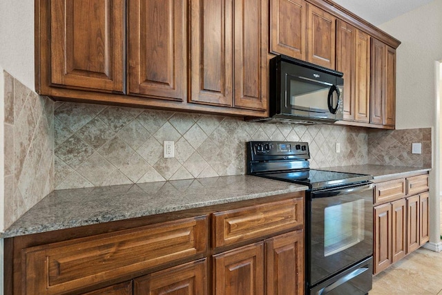 136 W Maple Dr, Granite Shoals, TX 78654 - kitchen with black appliances, decorative backsplash, brown cabinetry, and stone countertops