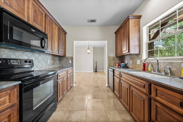 136 W Maple Dr, Granite Shoals, TX 78654 - kitchen with black appliances, a sink, backsplash, light stone counters, and baseboards