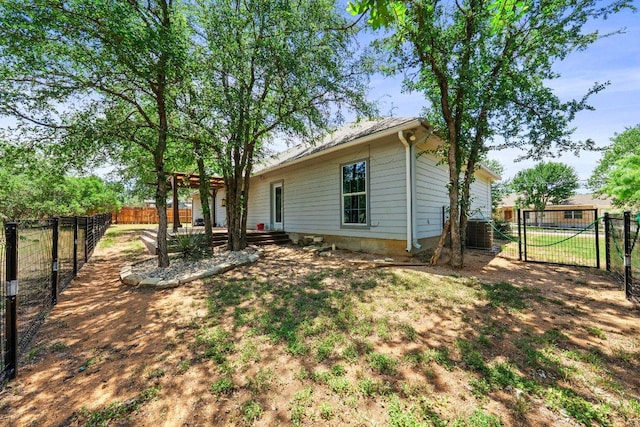 136 W Maple Dr, Granite Shoals, TX 78654 - back of property featuring a gate, a fenced backyard, and central AC