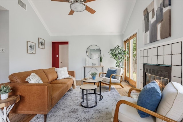 12319 Emery Oaks Rd, Austin, TX 78758 - living area featuring vaulted ceiling, wood finished floors, crown molding, a ceiling fan, and a fireplace