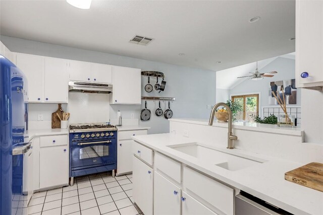 12319 Emery Oaks Rd, Austin, TX 78758 - kitchen with under cabinet range hood, gas range, a sink, light countertops, and lofted ceiling