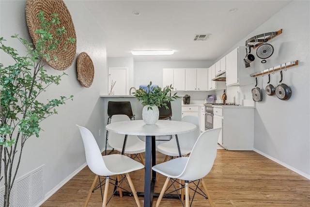 12319 Emery Oaks Rd, Austin, TX 78758 - dining room with light wood finished floors and baseboards