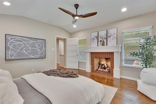 2905 Greenlawn Pkwy, Austin, TX 78757 - bedroom featuring vaulted ceiling, wood finished floors, a fireplace, baseboards, and recessed lighting