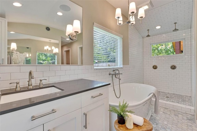 2905 Greenlawn Pkwy, Austin, TX 78757 - bathroom with a chandelier, vaulted ceiling, a freestanding tub, a tile shower, and vanity