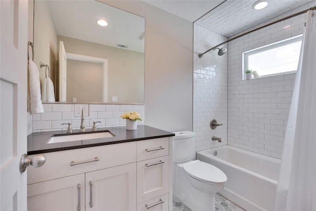 2905 Greenlawn Pkwy, Austin, TX 78757 - bathroom featuring toilet, shower / bath combination with curtain, vanity, and decorative backsplash