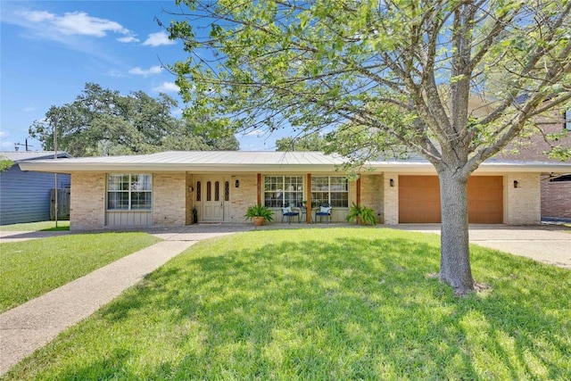 2905 Greenlawn Pkwy, Austin, TX 78757 - ranch-style house featuring brick siding, an attached garage, a front lawn, driveway, and a standing seam roof