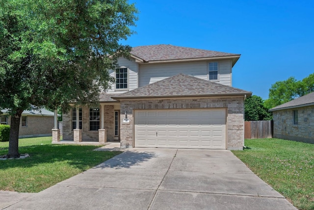 215 Gainer Dr, Hutto, TX 78634 - traditional-style home with a garage, driveway, brick siding, and roof with shingles