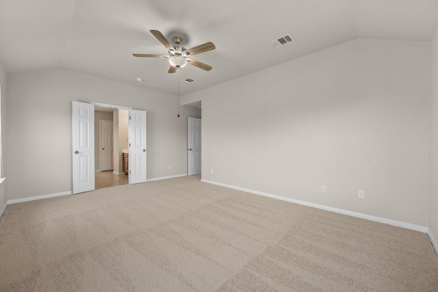 215 Gainer Dr, Hutto, TX 78634 - unfurnished bedroom featuring vaulted ceiling, baseboards, light colored carpet, a ceiling fan, and connected bathroom