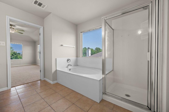 215 Gainer Dr, Hutto, TX 78634 - bathroom with a bath, tile patterned floors, a shower stall, and baseboards